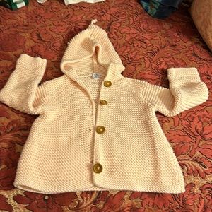 Baby organic cotton hooded cardigan in pale coral.